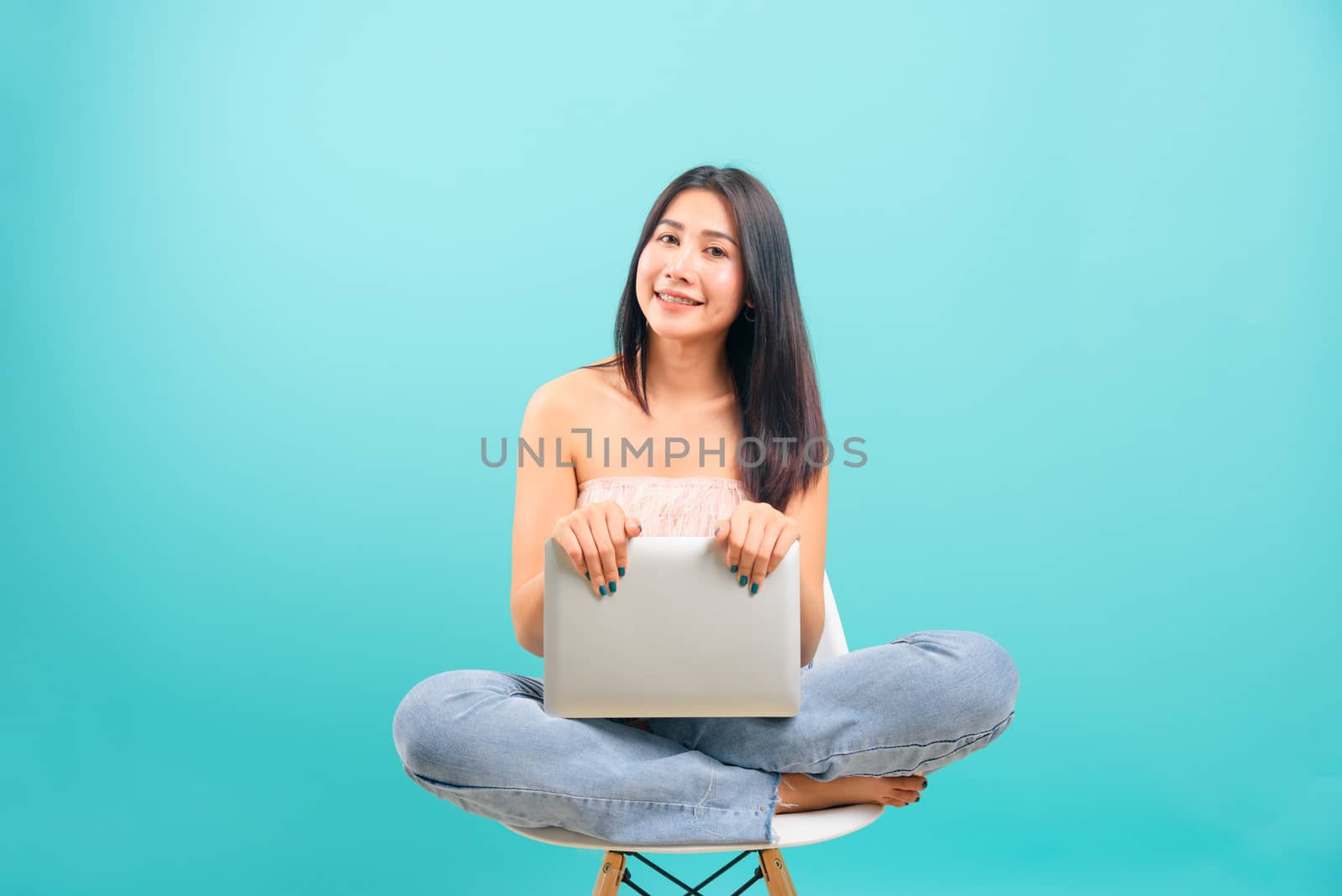 Smiling face portrait asian beautiful woman sitting on white cha by Sorapop