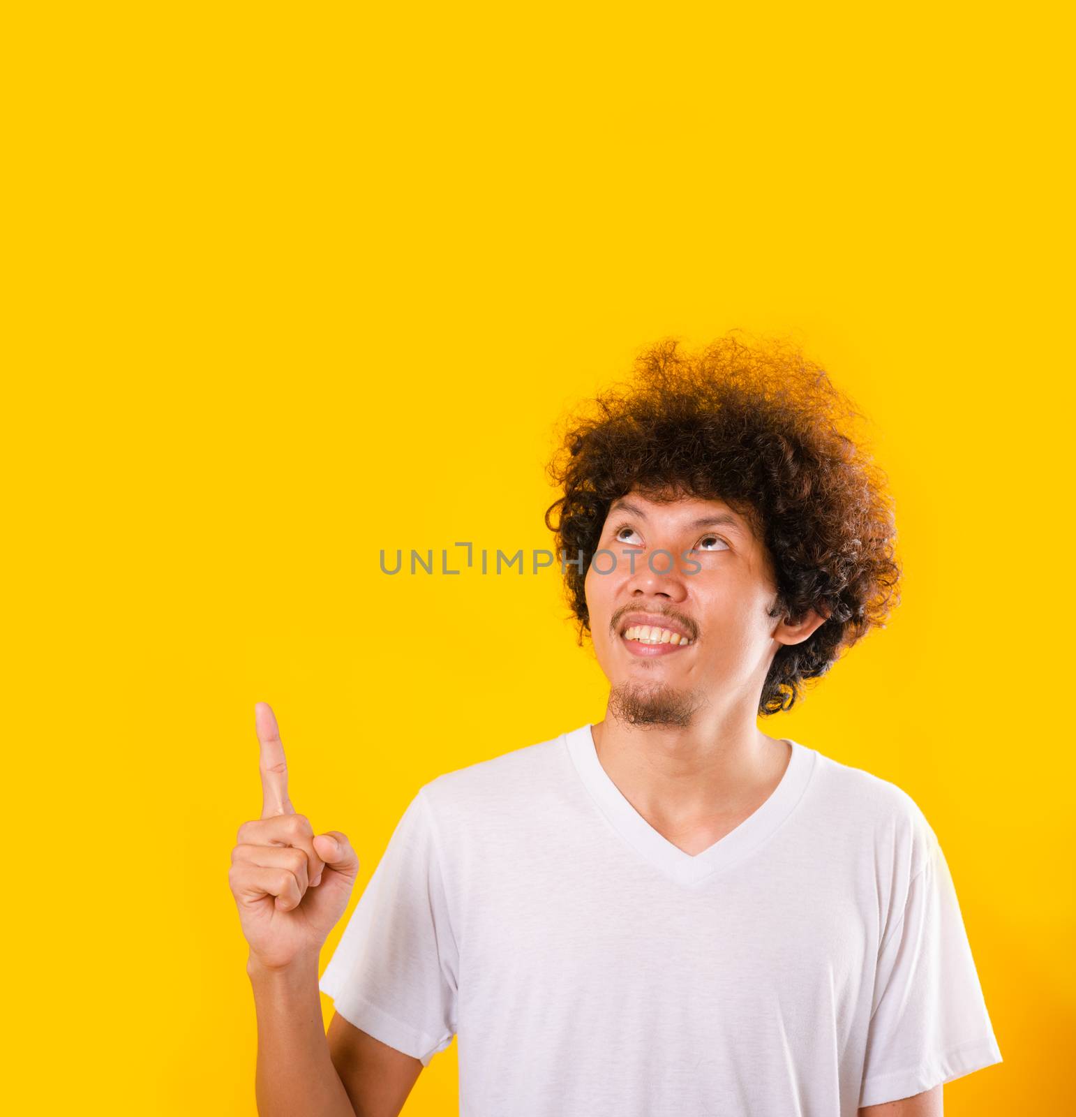 Asian Portrait happy young man curly hair pointing fingers away  by Sorapop