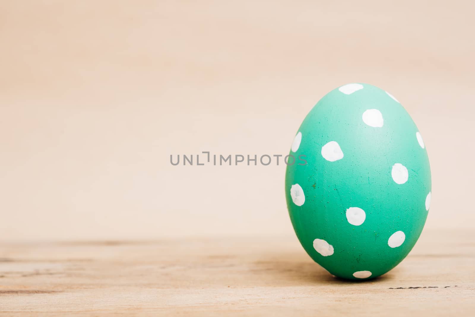 Beautiful Easter Green egg on wooden background, Easter day concept