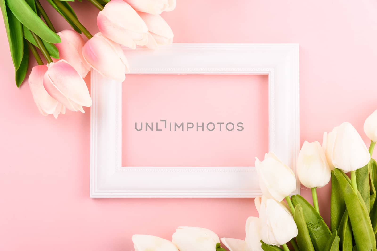 Happy Women's Day, Mother's Day concept. top view flat lay Tulip flower and photo frame on pink background, copy space for your text