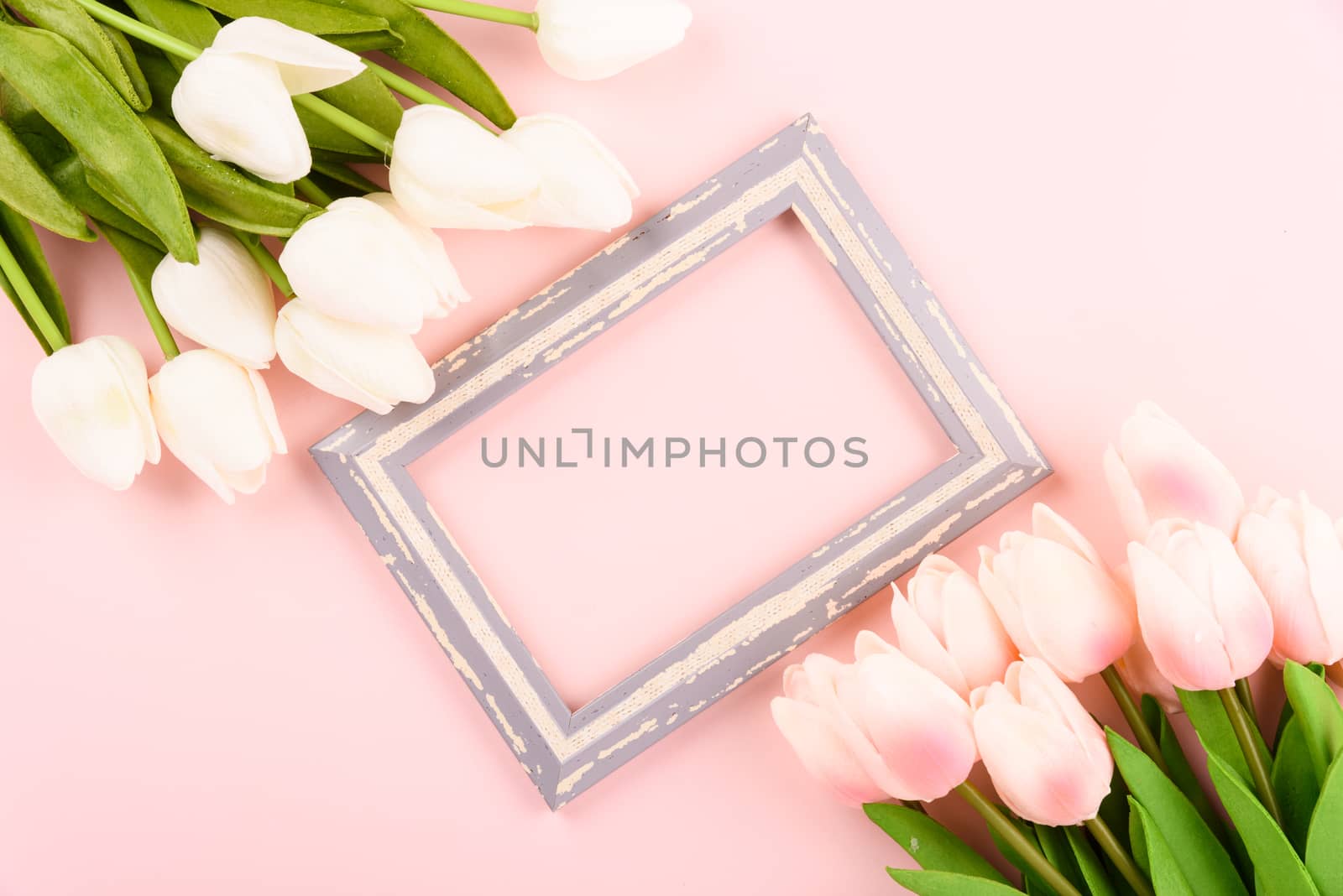 Happy Women's Day, Mother's Day concept. top view flat lay photo frame and Tulip flower on pink background, copy space for your text