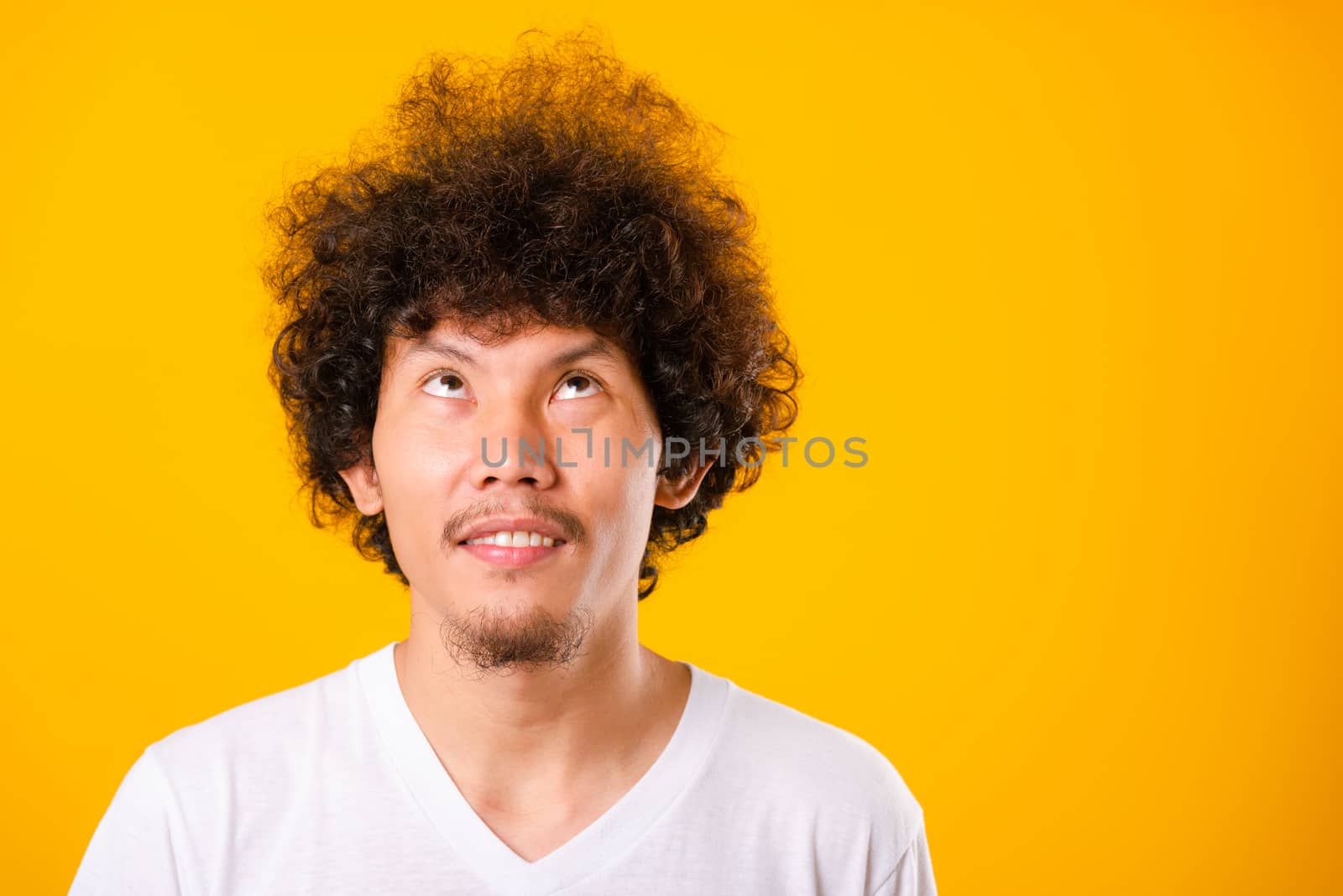 Asian handsome man with curly hair looking up see he hair isolat by Sorapop