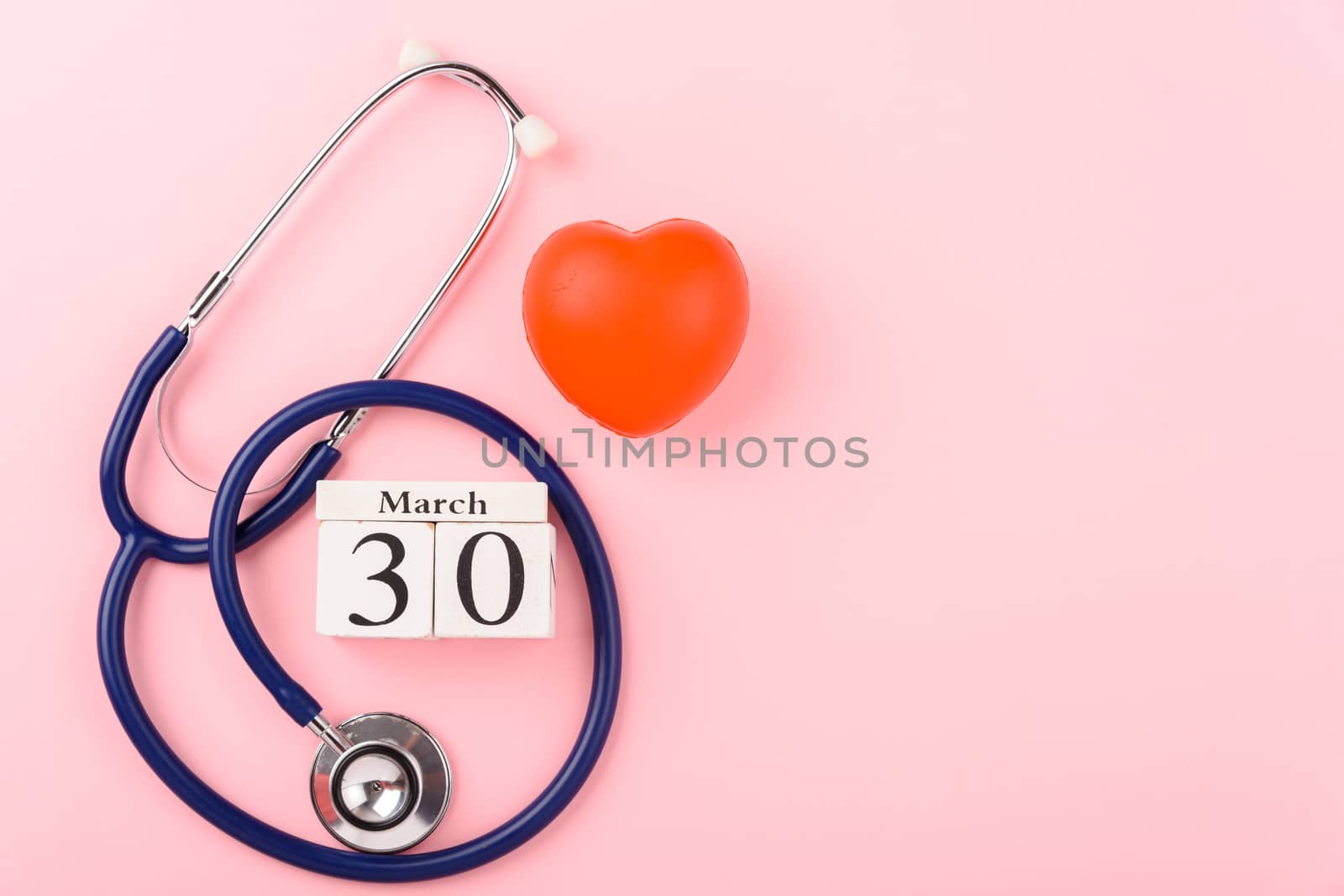Doctor's Day concept, flat lay top view, equipment medical red heart and stethoscope on pink background, care patient in hospital with copy space for text