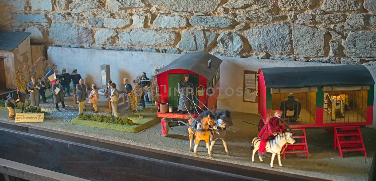 Small scale model toys of an circus and people gathered for a photograph