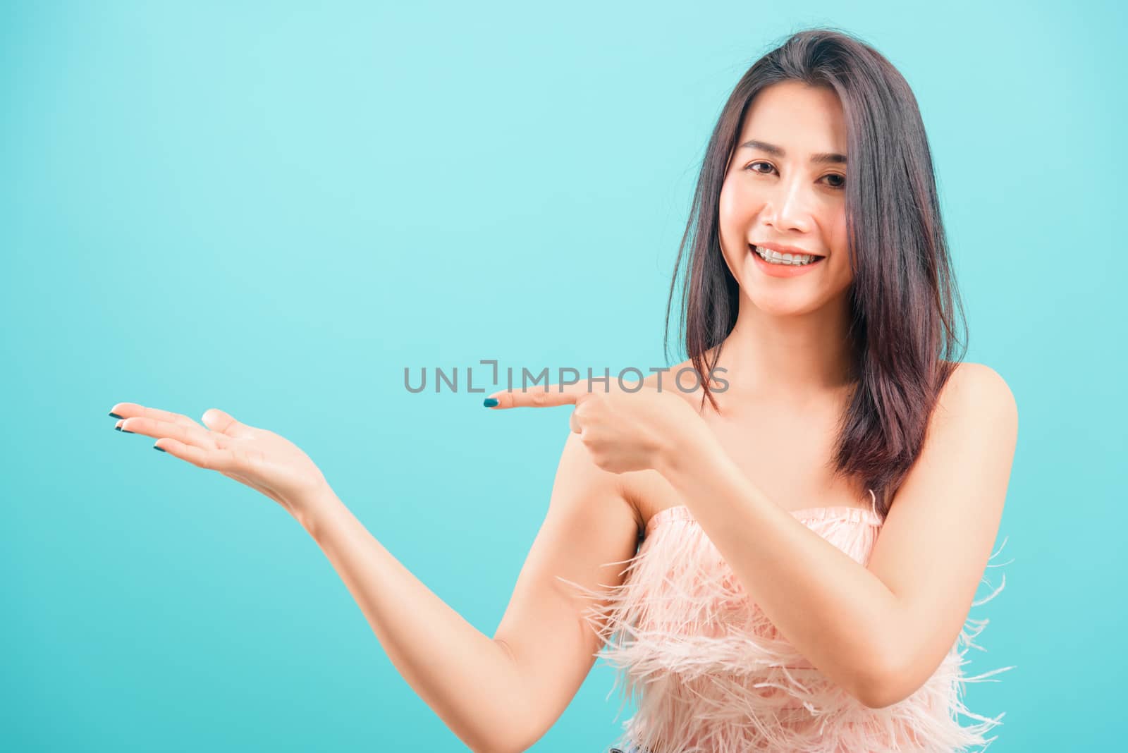 Smiling face Asian beautiful woman her point finger beside and l by Sorapop