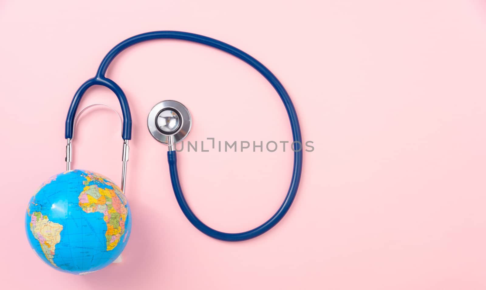 World health day concept, Stethoscope, globe on pink background with copy space. Global health care