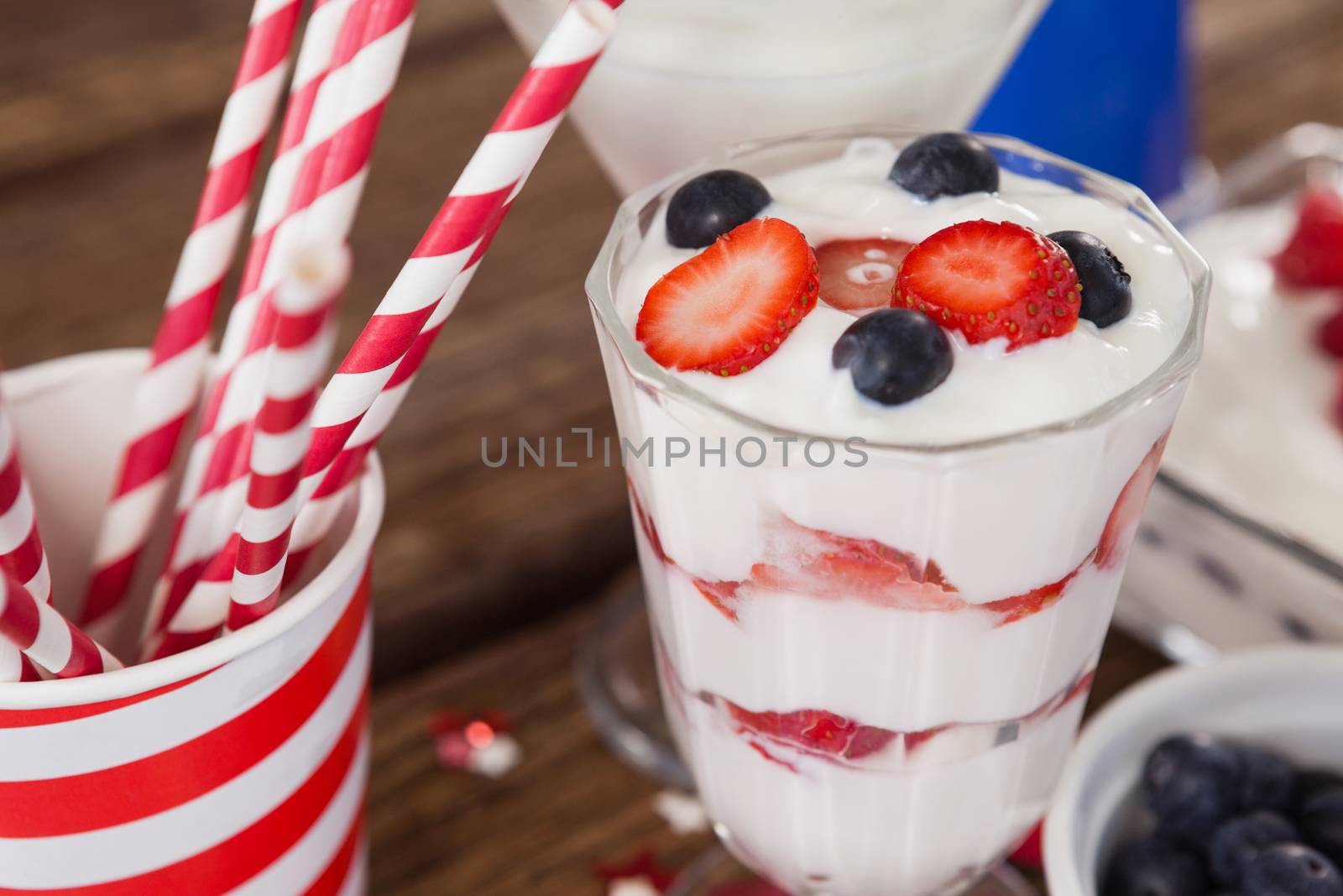Close-up of fruit ice cream and straw with 4th july theme