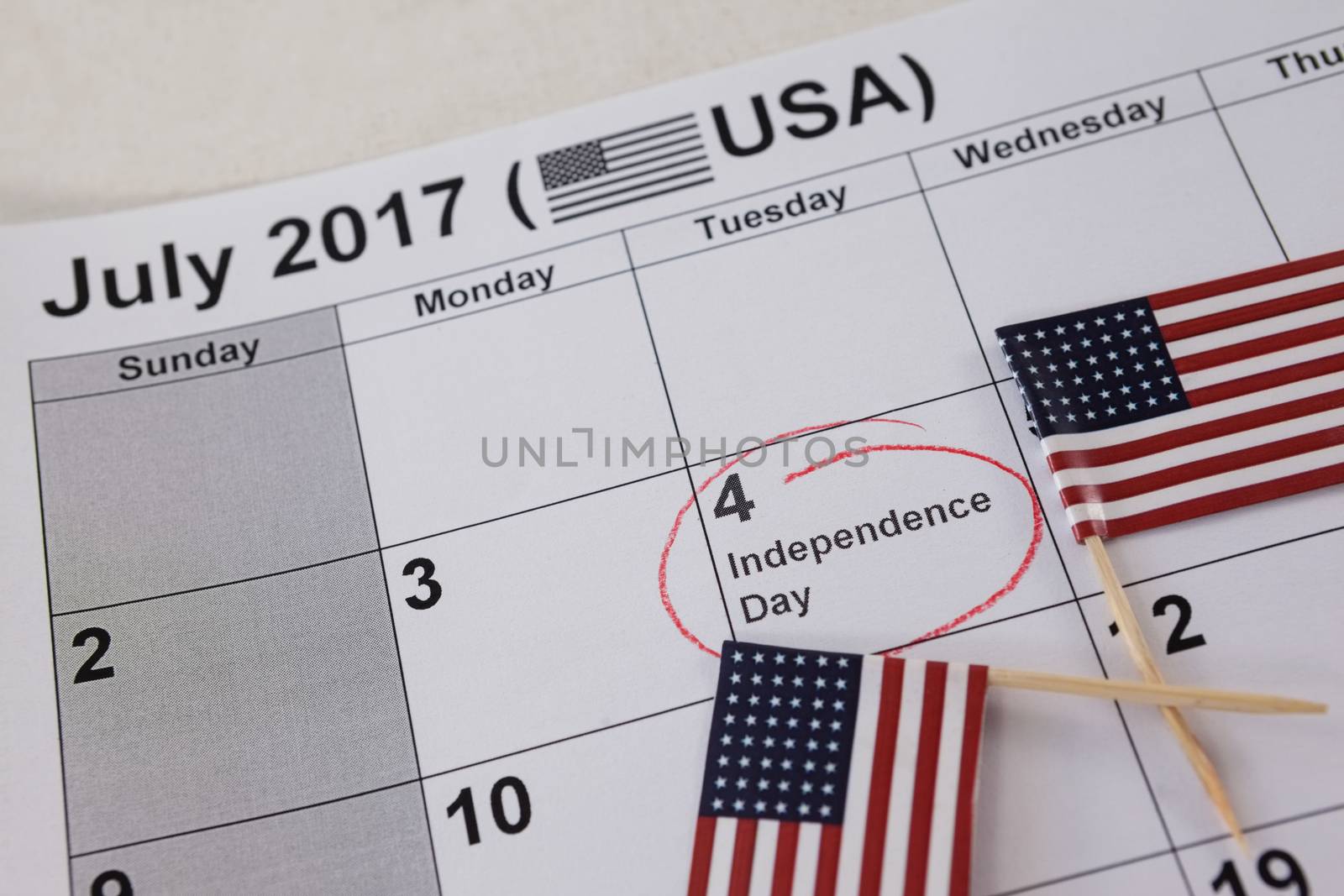 Close-up of American flags arranged on calendar with 4th july theme
