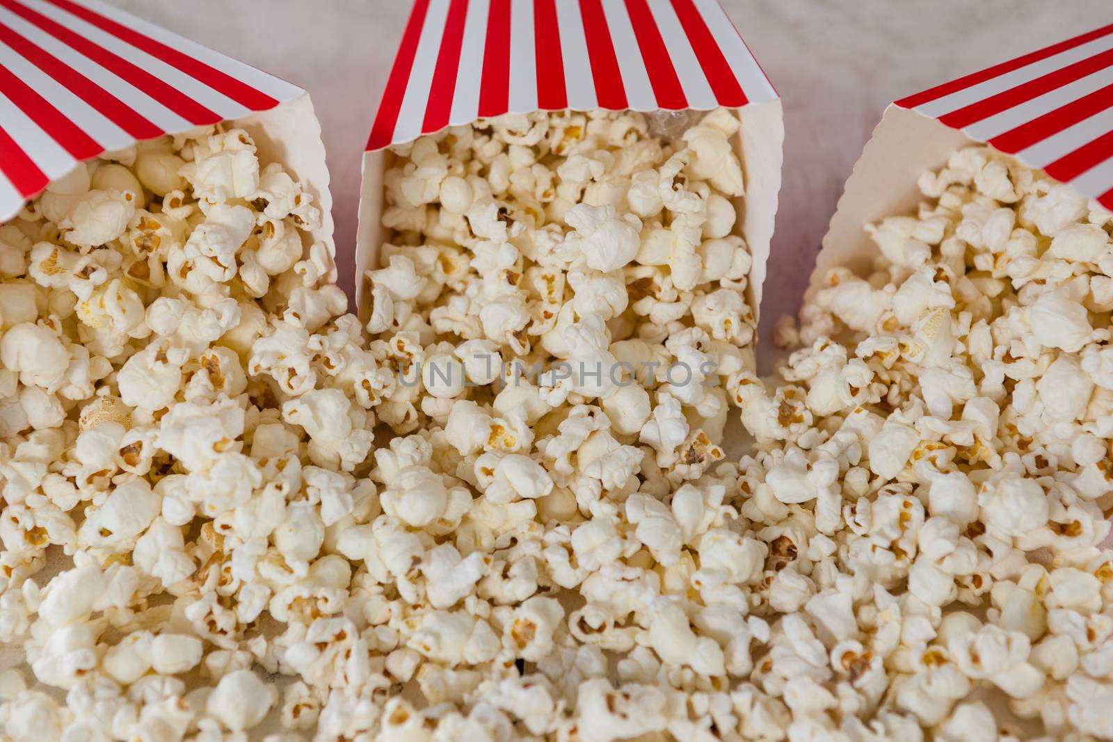 Close-up of scattered popcorn on wooden table with 4th july theme