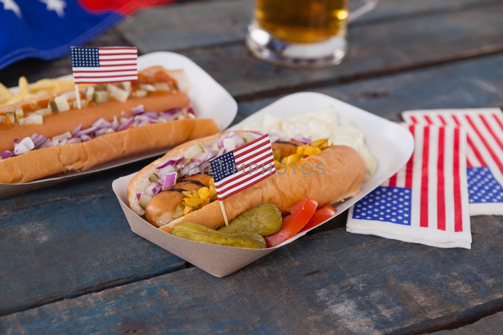 Hot dogs decorated with 4th july theme on wooden table