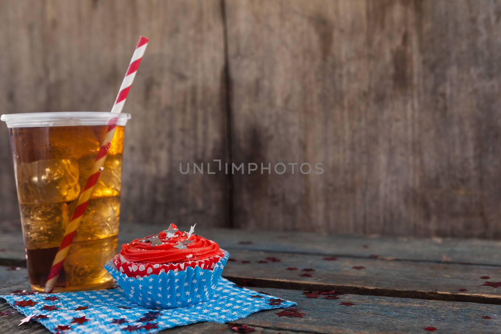 Decorated cupcake and cold drink with 4th july theme by Wavebreakmedia