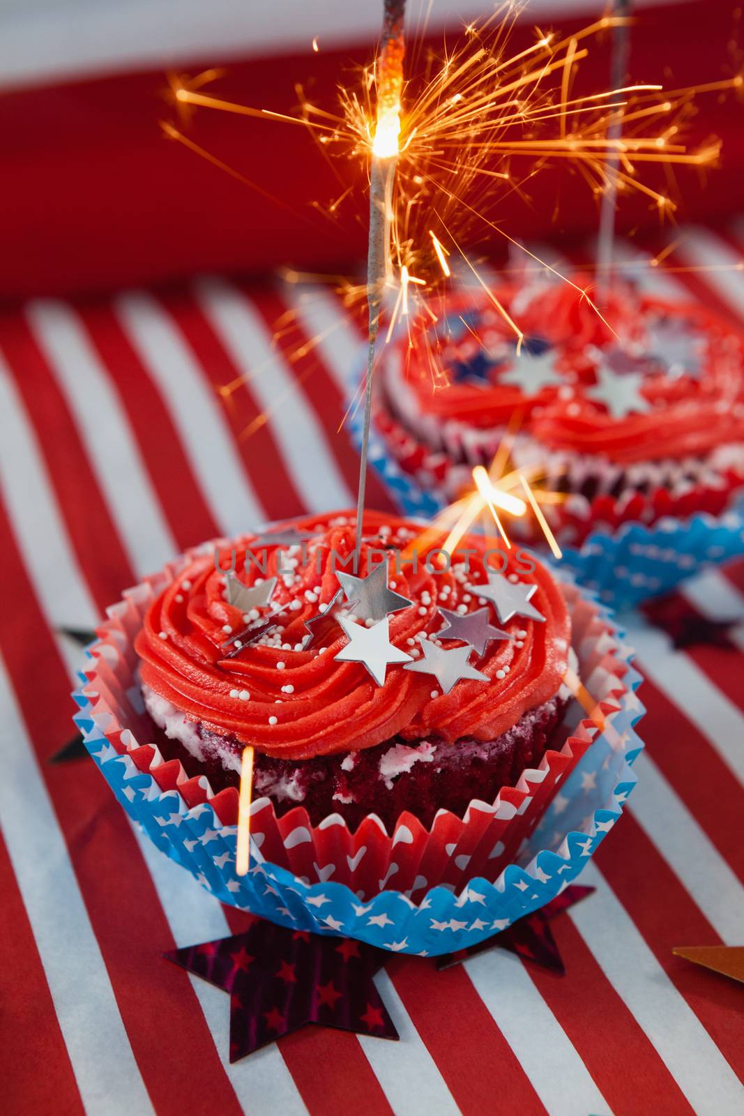 Burning sparkler on decorated cupcakes with 4th july theme