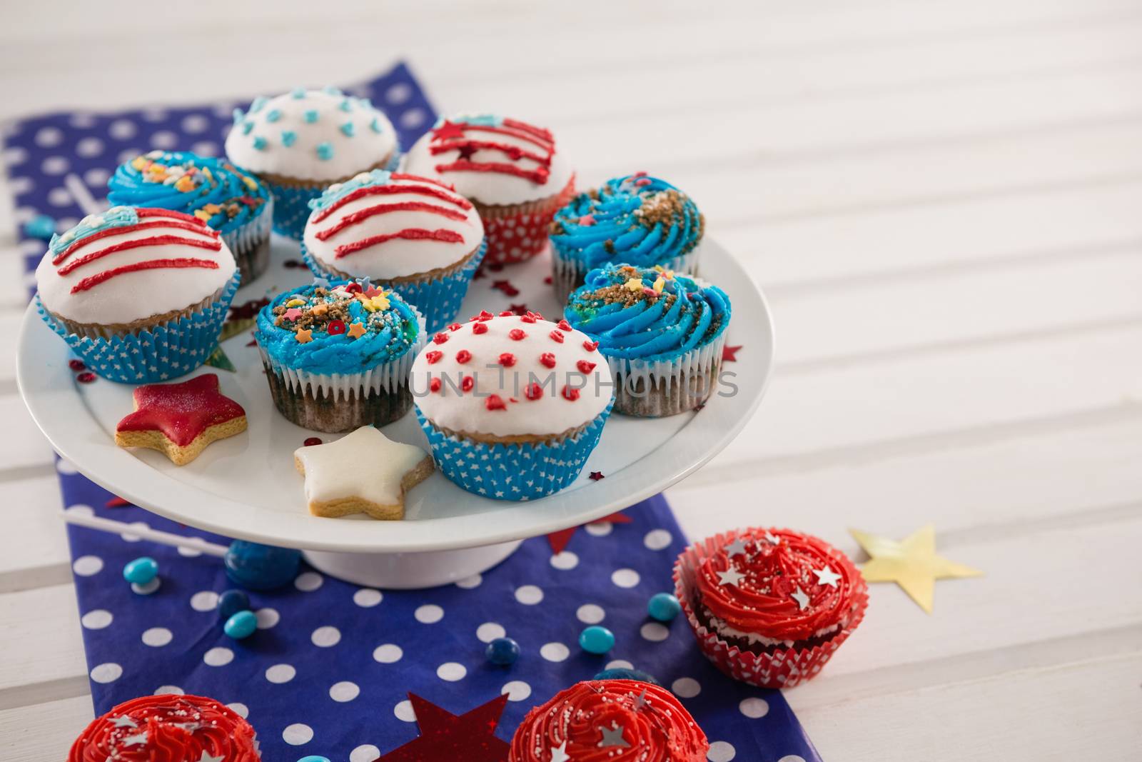 Decorated cupcakes with 4th july theme arranged on plate