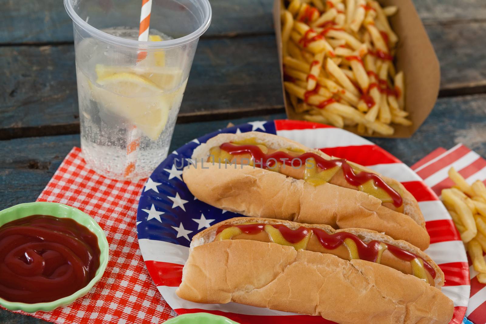 Hot dog served on plate with french fries by Wavebreakmedia