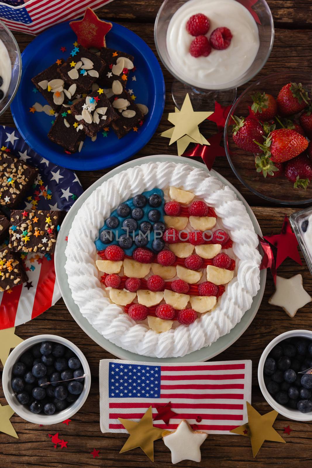 Fruitcake and various sweet foods arranged on wooden table by Wavebreakmedia
