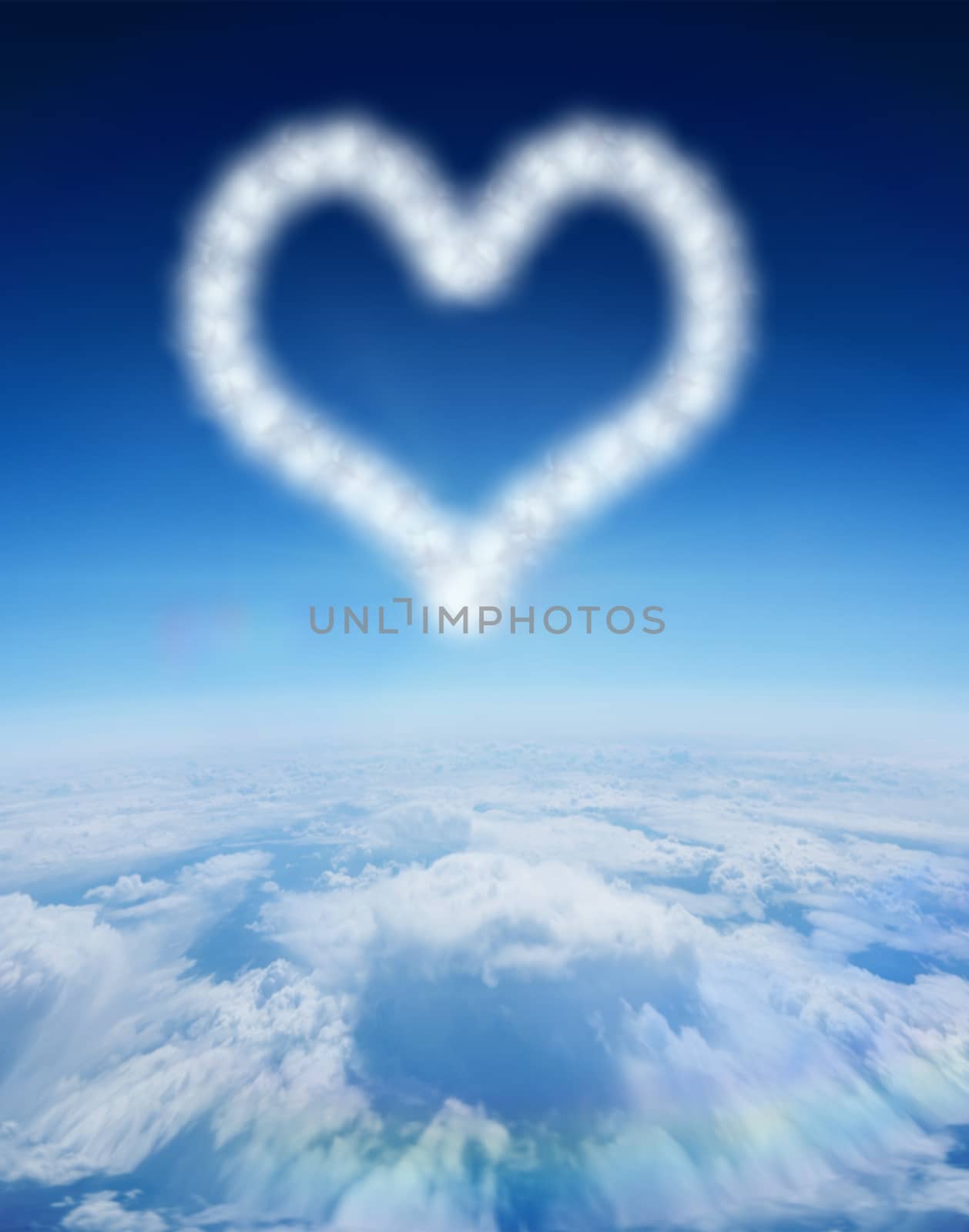 Cloud in shape of heart against blue sky over clouds at high altitude