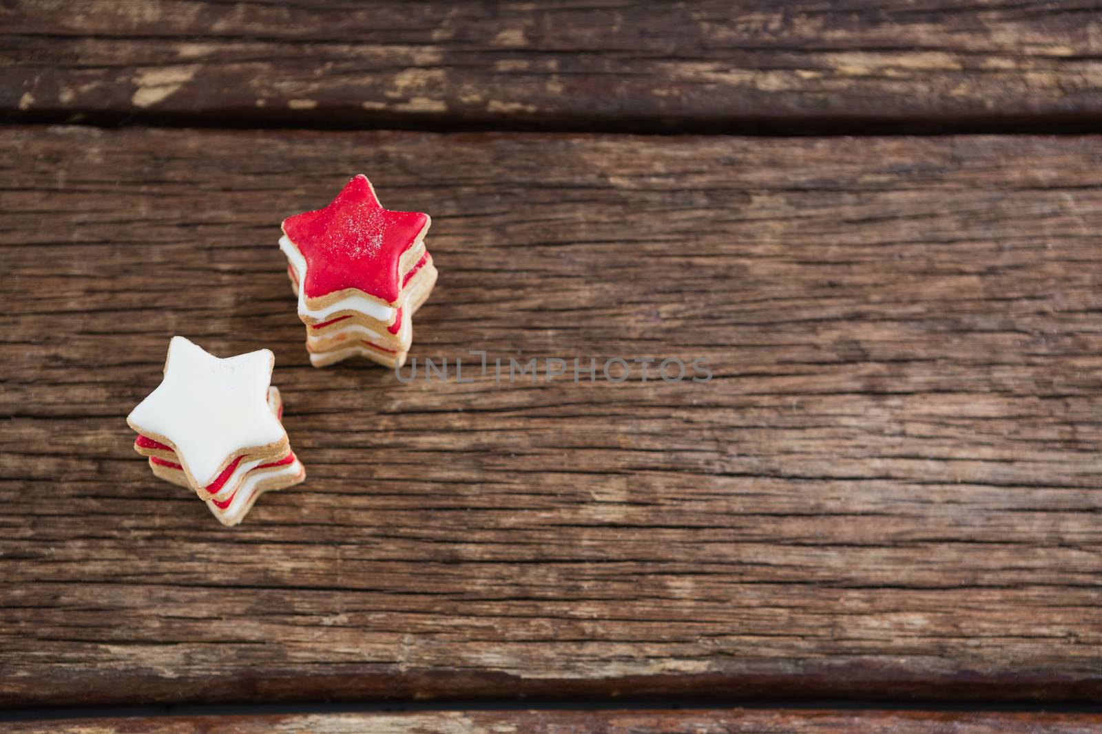 Red and white sugar cookies stacked on wooden table for 4th of July