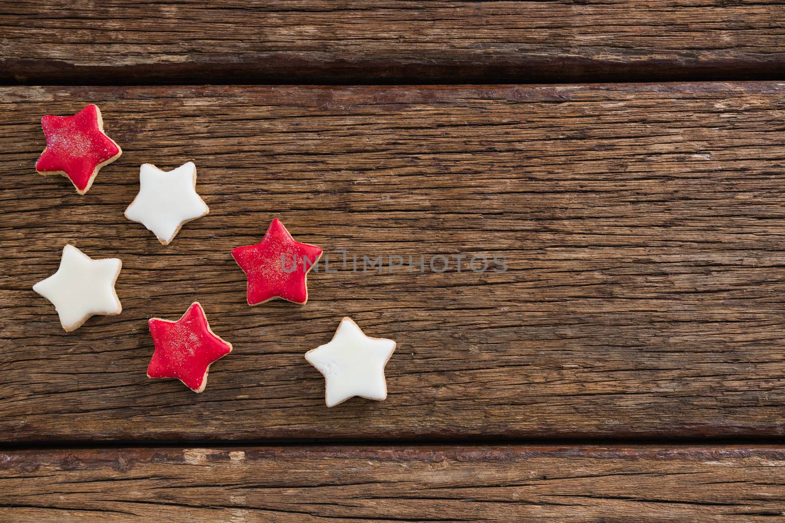 Red and white sugar cookies arranged on wooden table for 4th of July