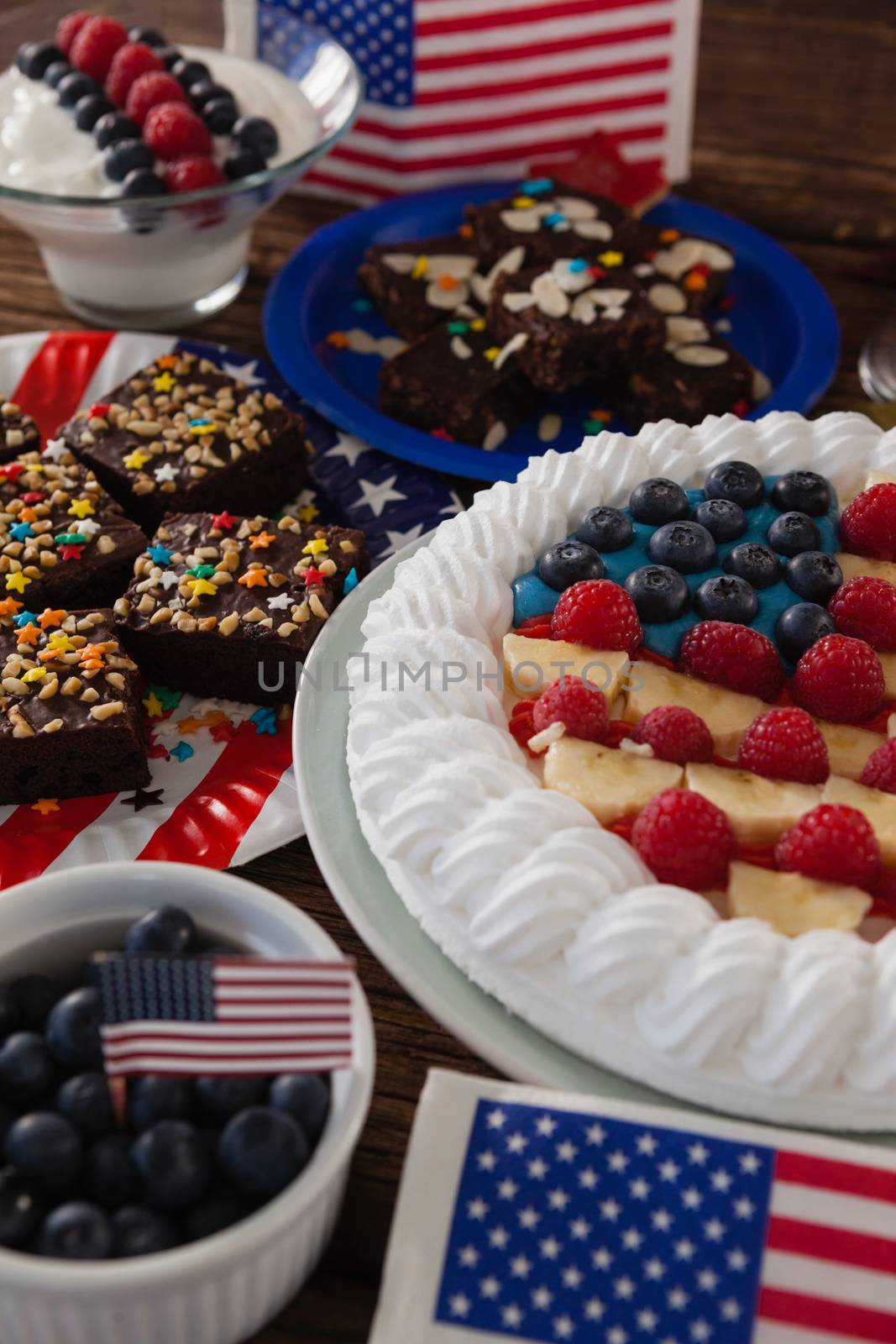 Fruitcake served in plate on wooden table with 4th July theme