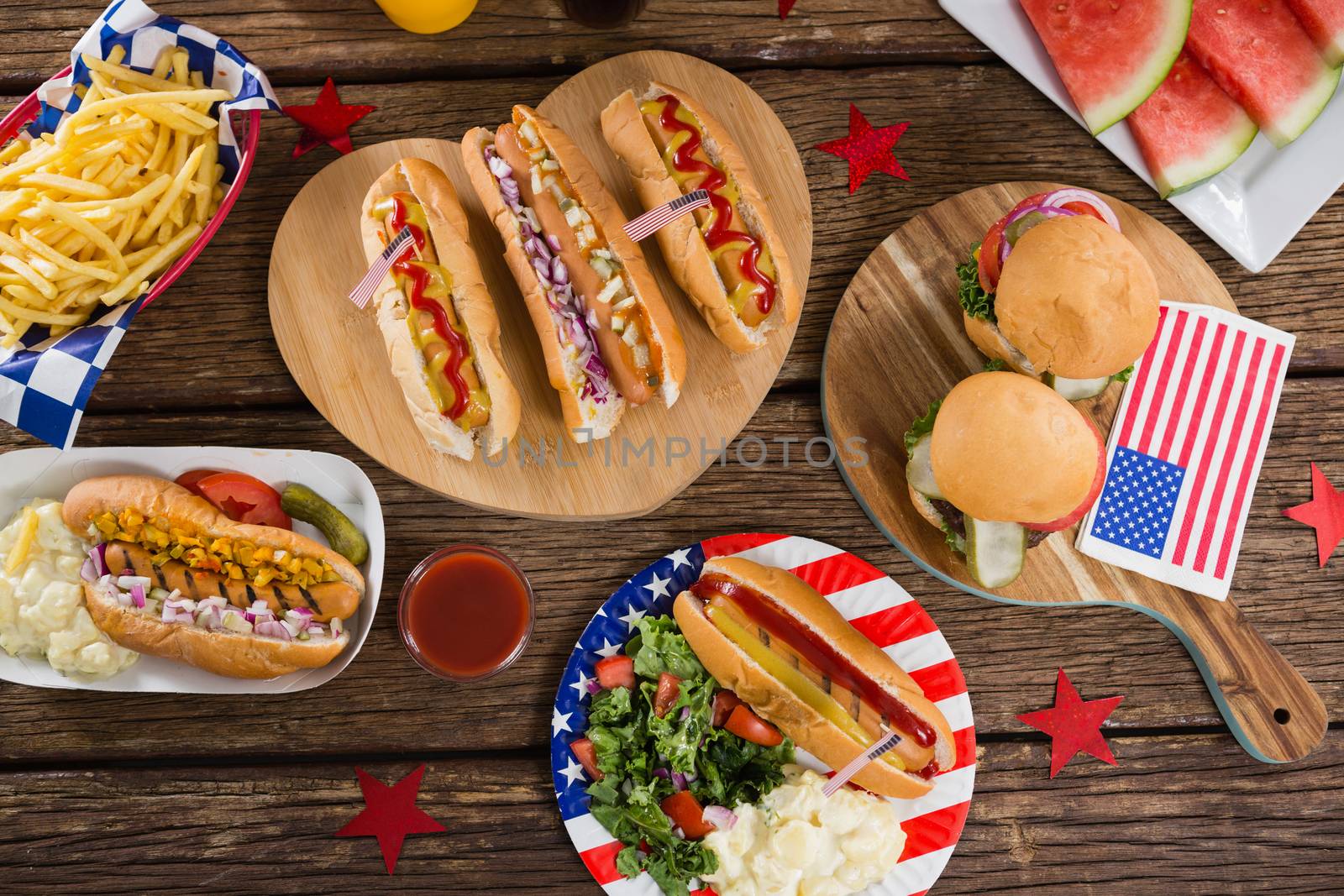 Hot dogs on wooden table with 4th july theme by Wavebreakmedia