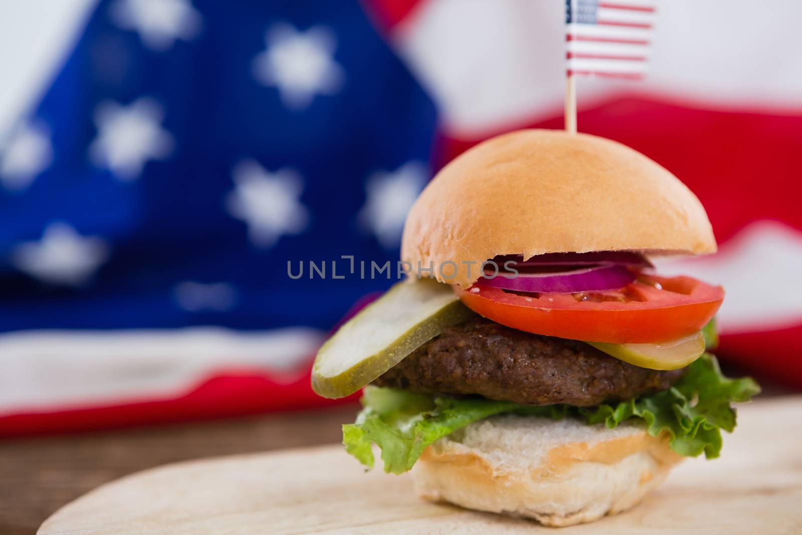 Burger on wooden table with 4th july theme by Wavebreakmedia