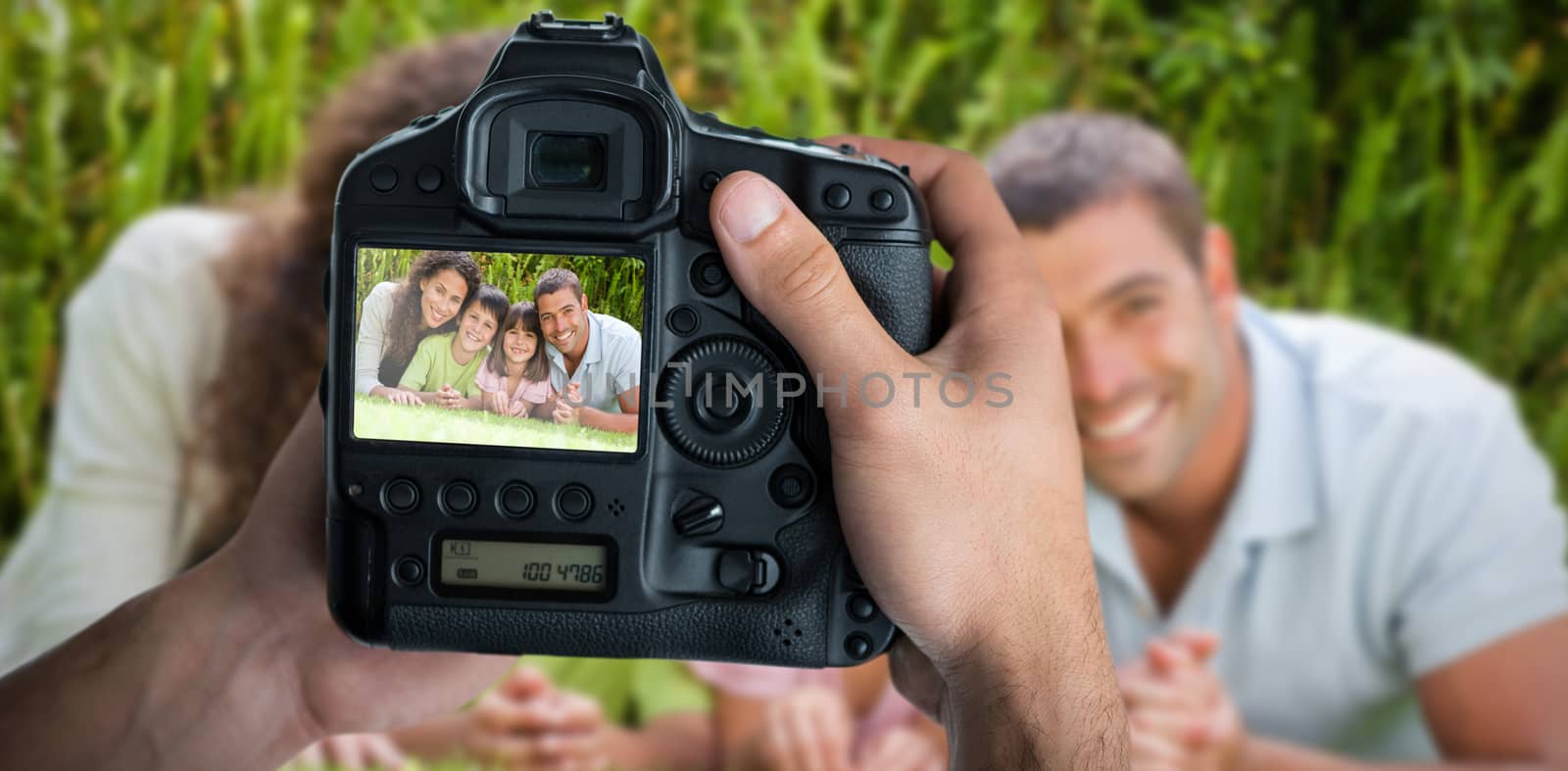 Cropped image of hands holding camera  against apps banner on abstract screen 