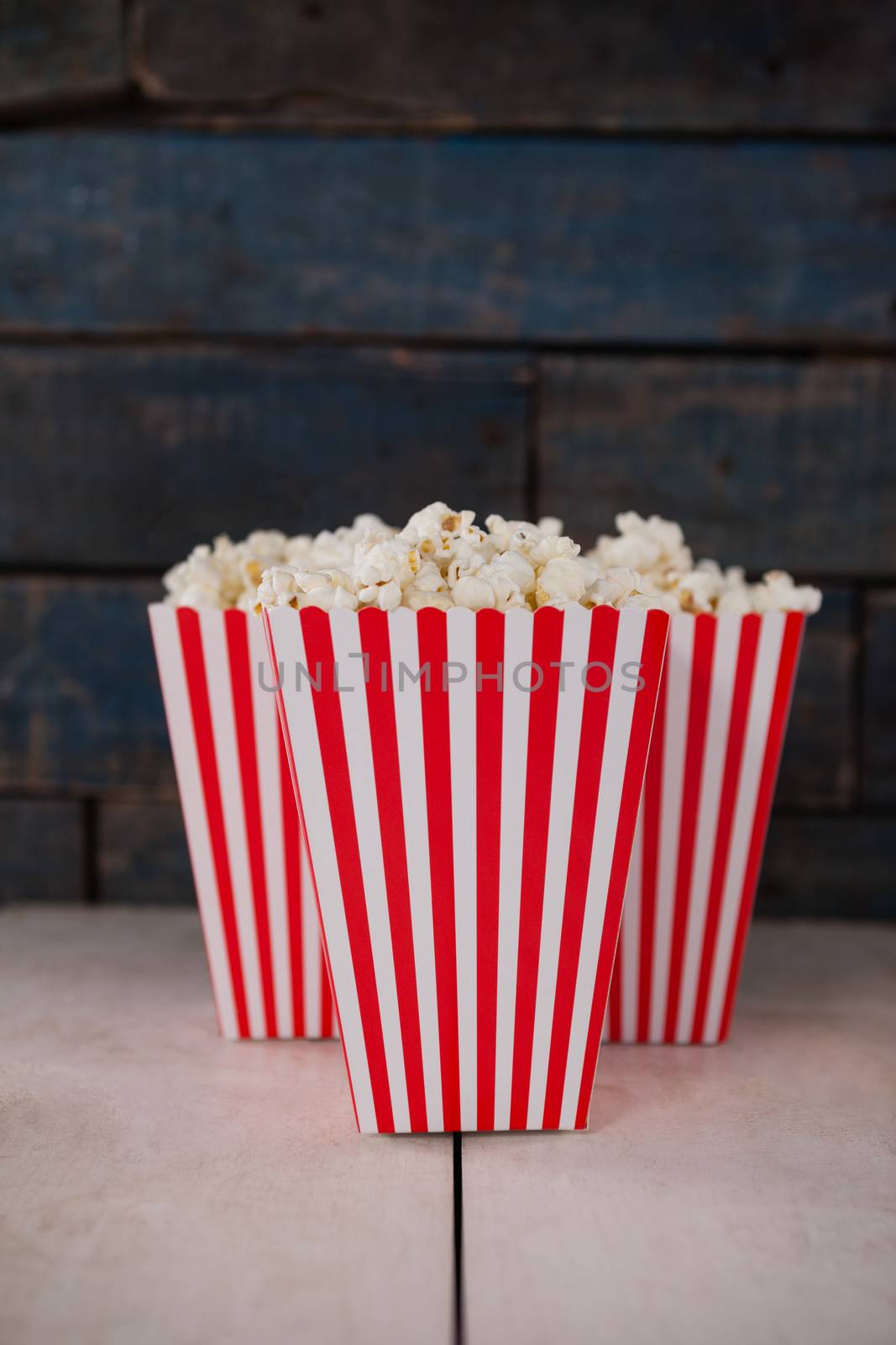 Popcorn arranged on wooden table with 4th july theme