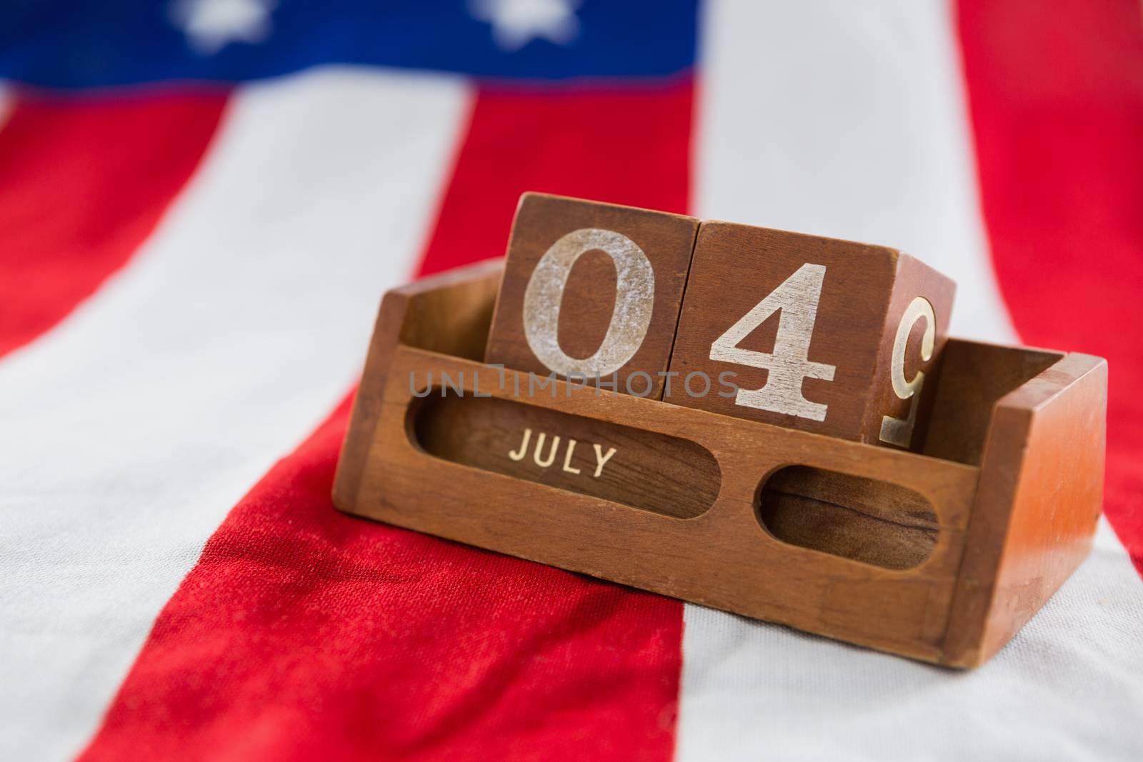 Date blocks on American flag with 4th july theme by Wavebreakmedia