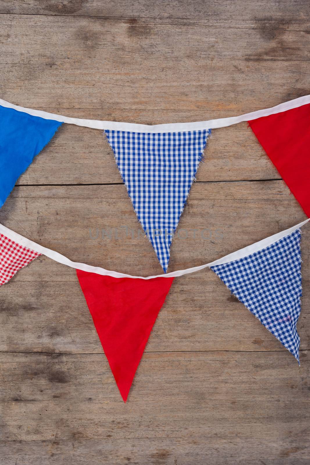 Bunting flags arranged on wooden table by Wavebreakmedia