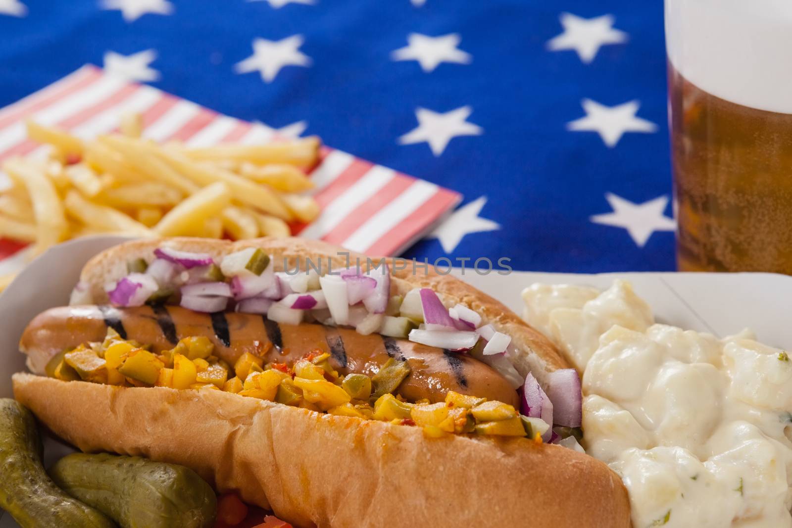 Hot dog and french fries on wooden tale with 4th july theme