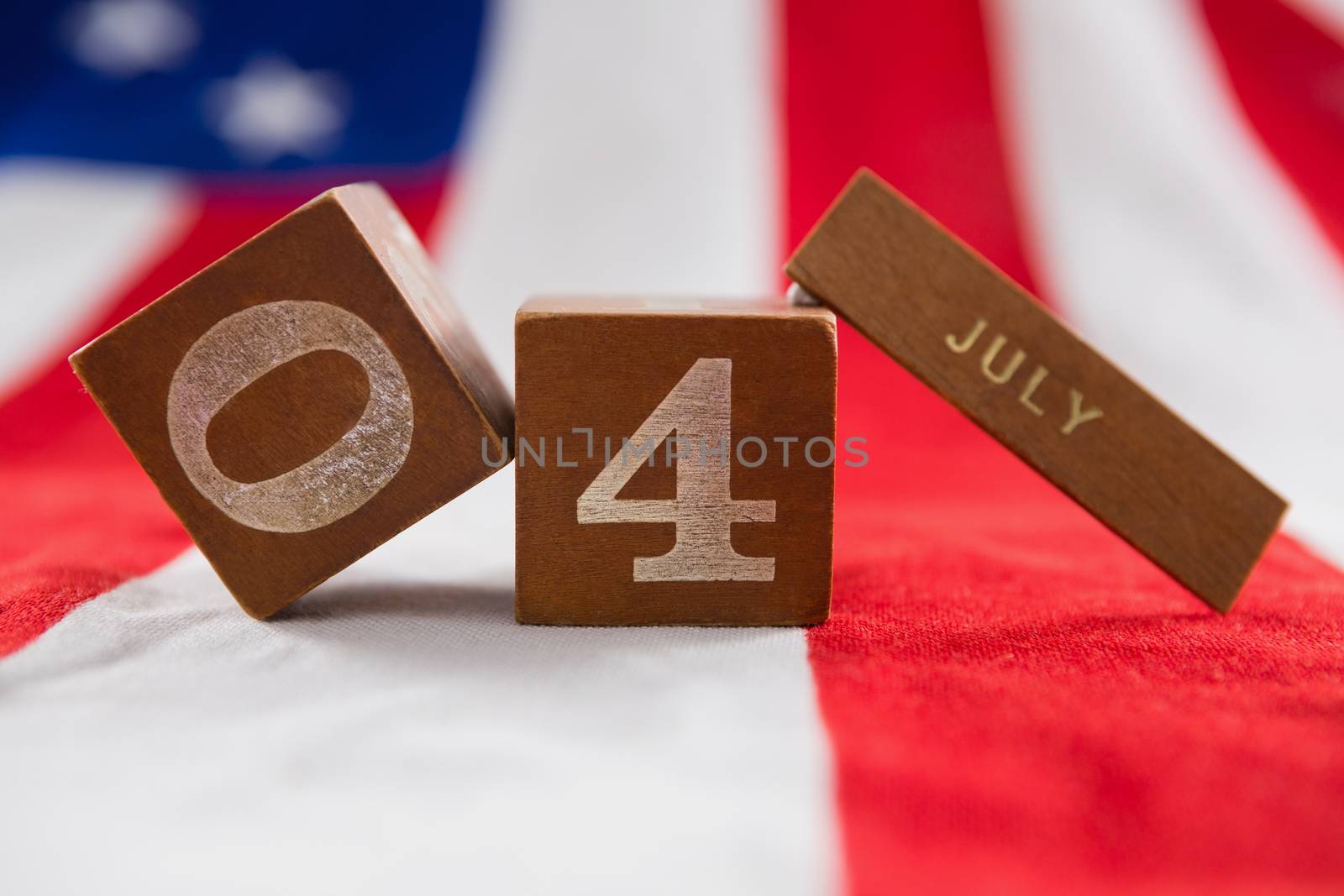 Close-up of date blocks on American flag with 4th july theme
