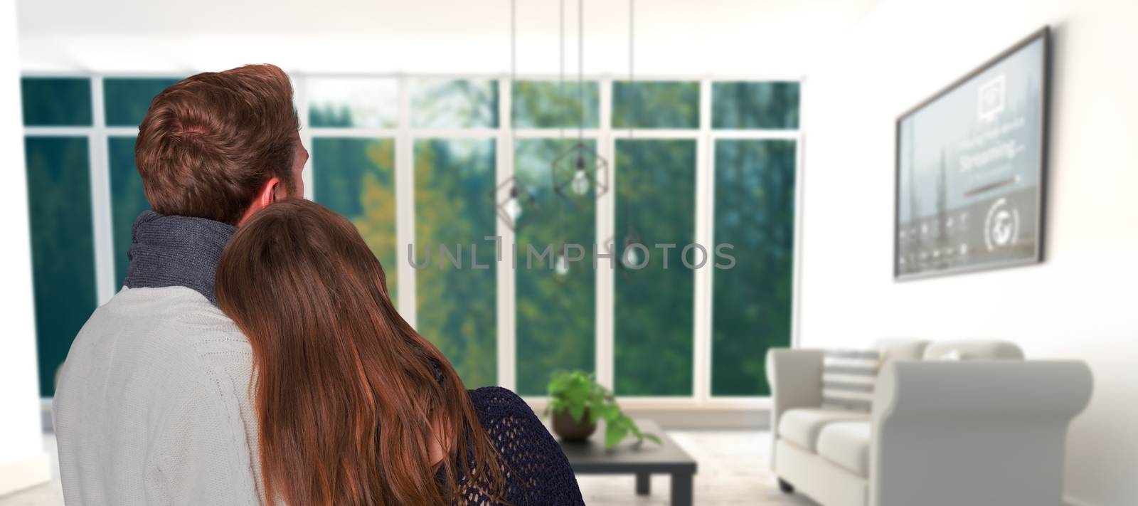 Close up rear view of romantic couple against white sofas on floor in modern living room