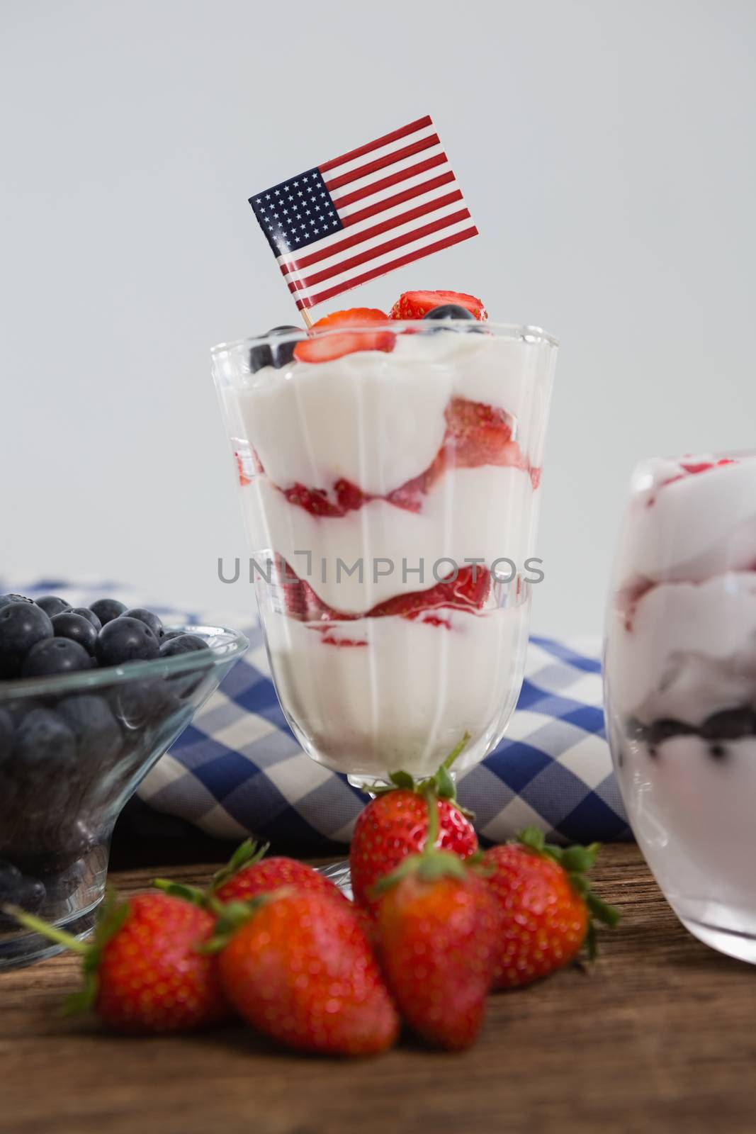 Close-up of fruit ice cream on wooden table with 4th july theme