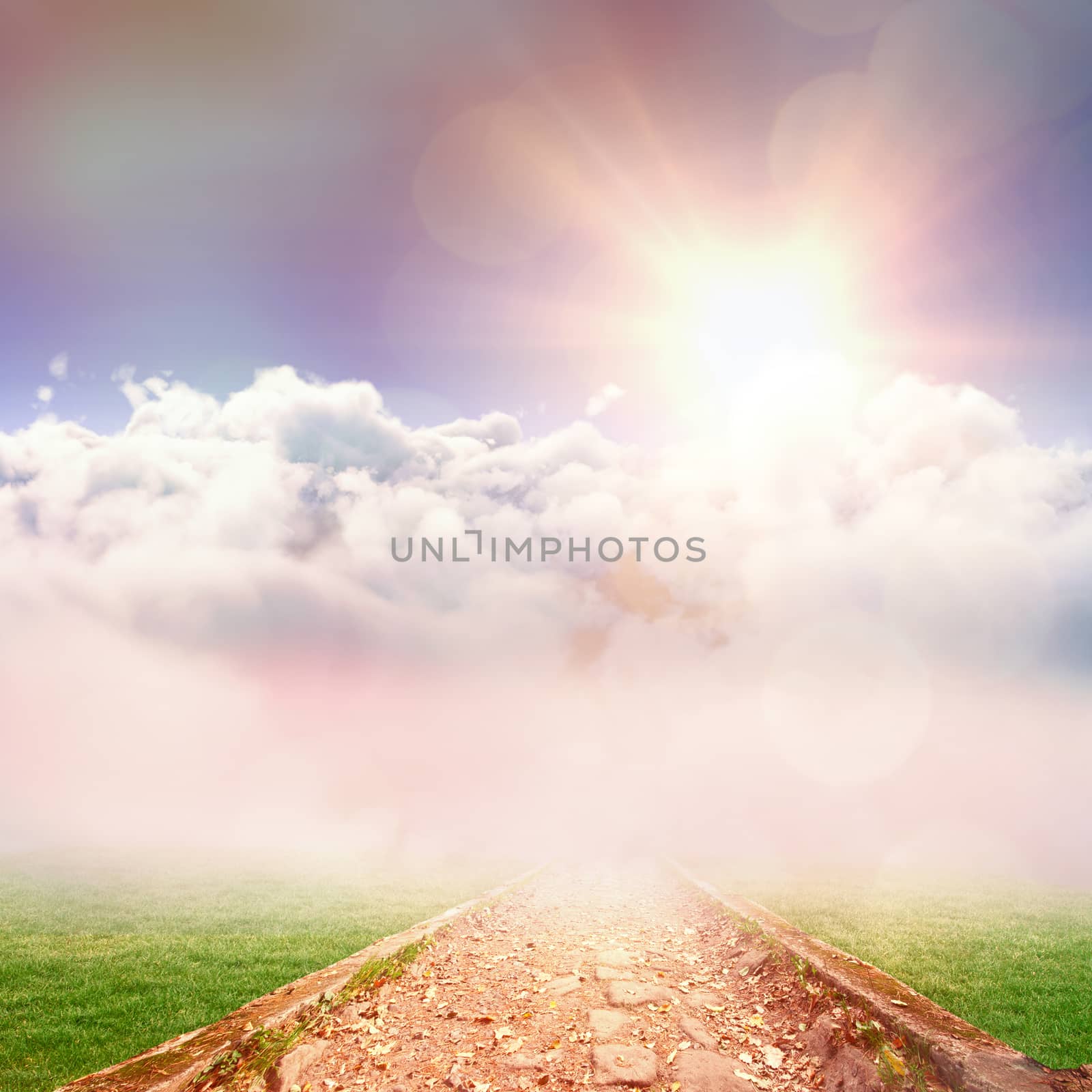 Idyllic view of white cloudscape against sky against path on grass