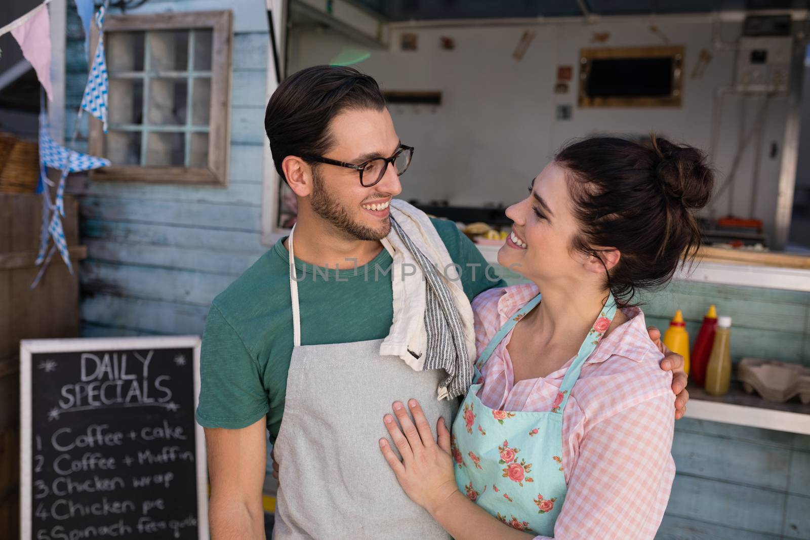 Romantic waiter and waitress looking at each other at counter