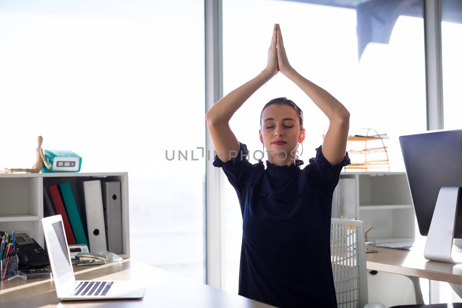 Female executive doing yoga by Wavebreakmedia