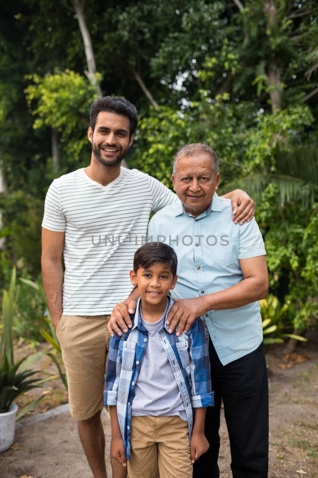 Portrait of smiling family standing against plants by Wavebreakmedia