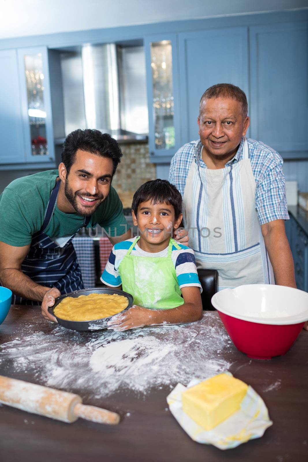 Portrait of happy family preparing food by Wavebreakmedia