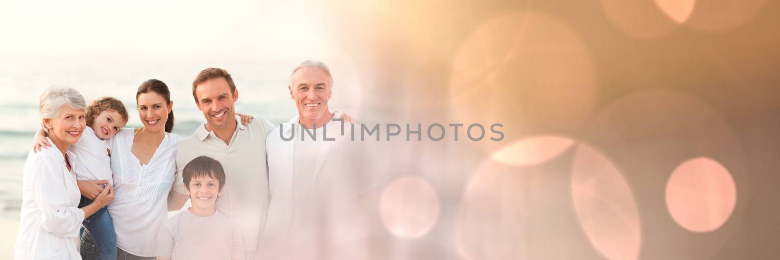 Family at beach with peach bokeh transition by Wavebreakmedia