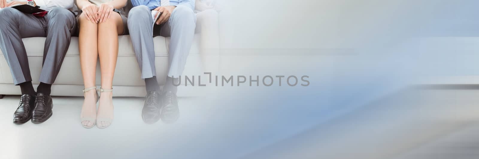 Digital composite of Close up of business people legs on couch with blurry blue and grey transition