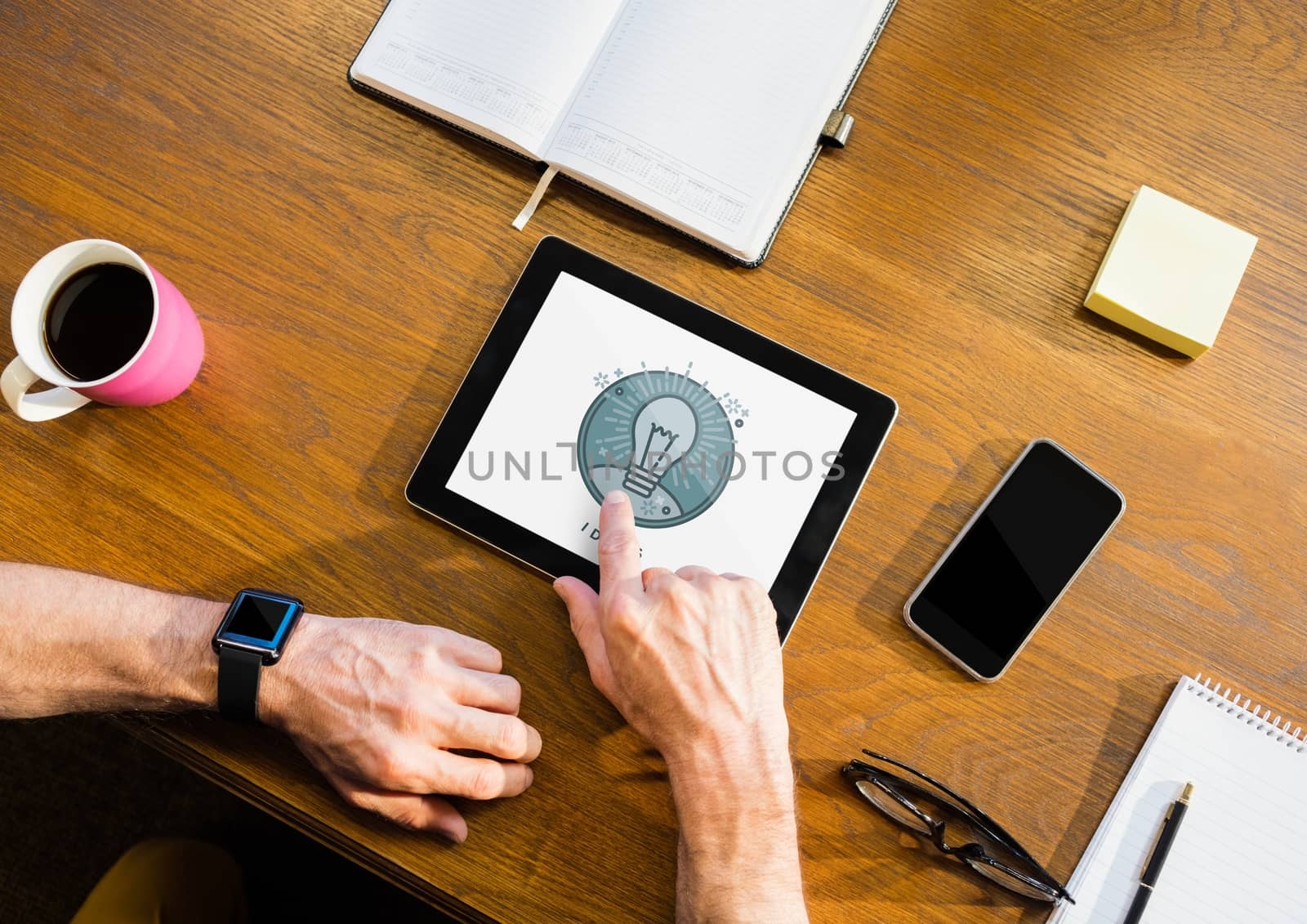Digital composite of Person using a tablet with education icon on the screen