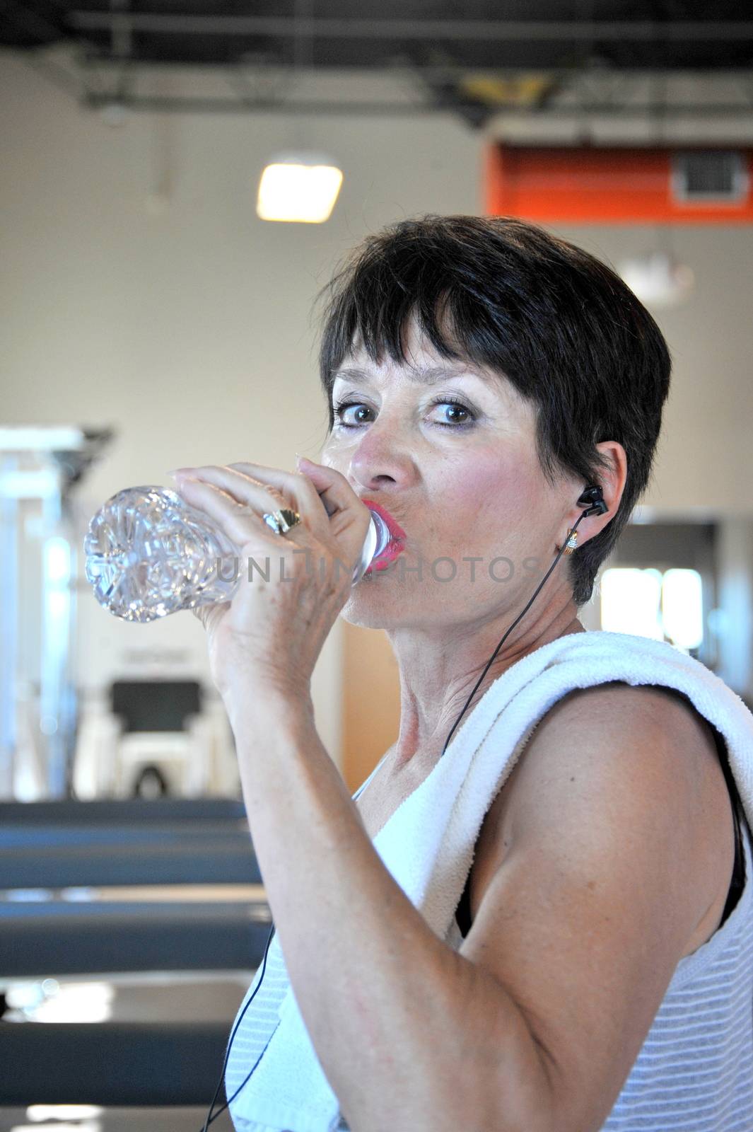 Mature female beauty working out inside a health club.