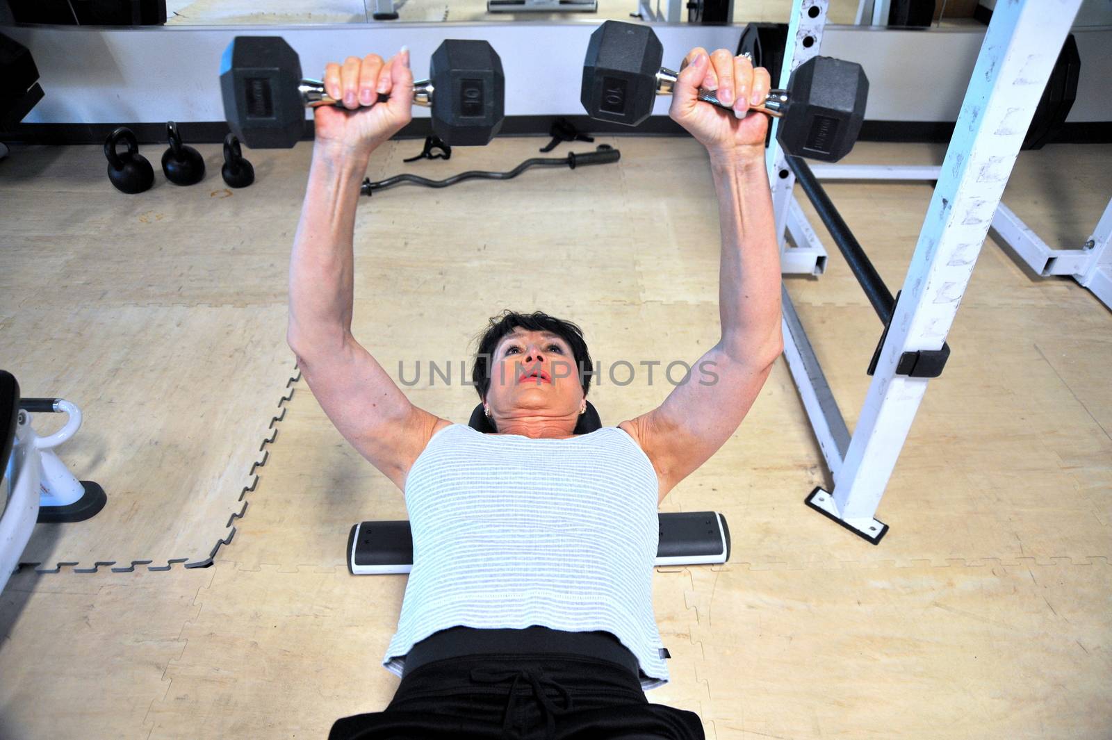 Mature female beauty working out inside a health club.