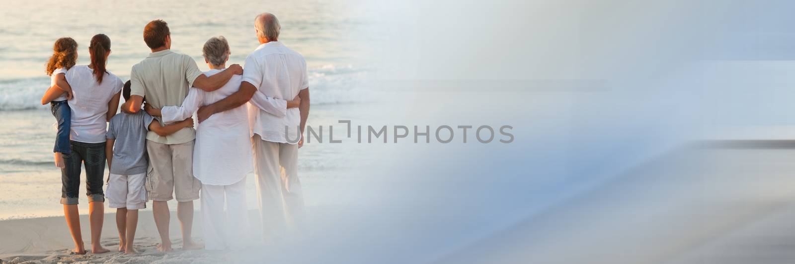 Back of family at beach with blue and grey transition by Wavebreakmedia