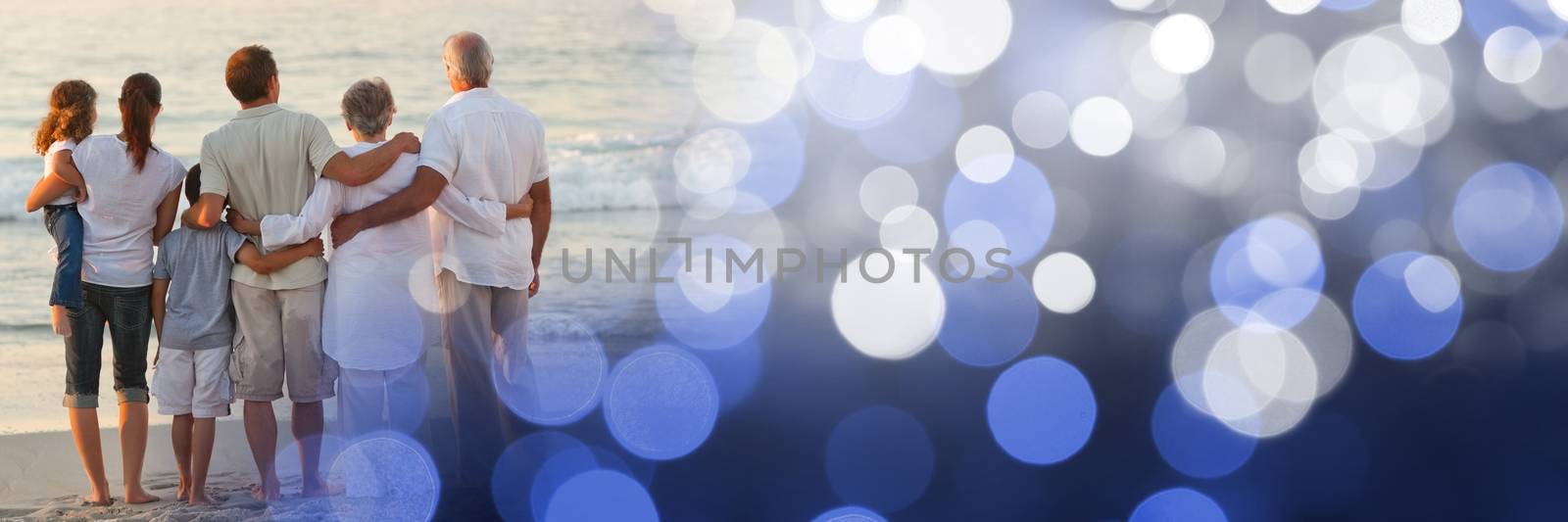 Digital composite of Back of family at beach with blue bokeh transition