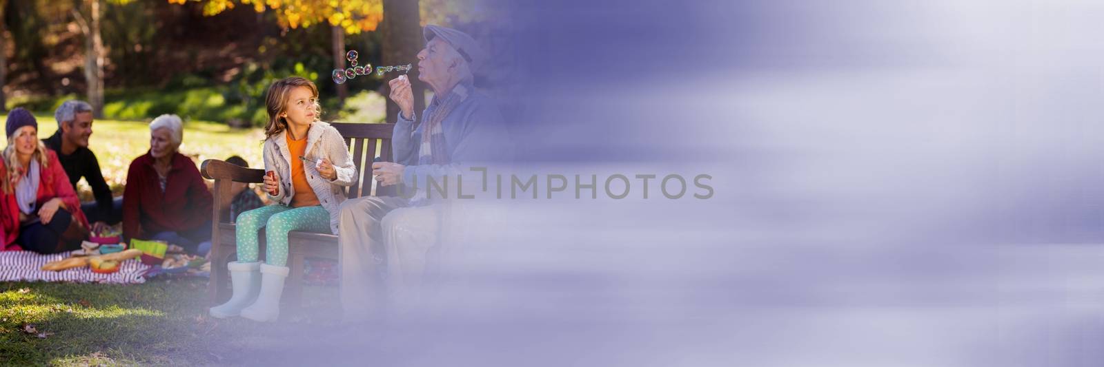 Family in park blowing bubbles and blurry purple transition by Wavebreakmedia
