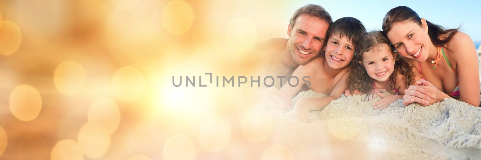 Digital composite of Family at beach with sand castles and yellow bokeh transition