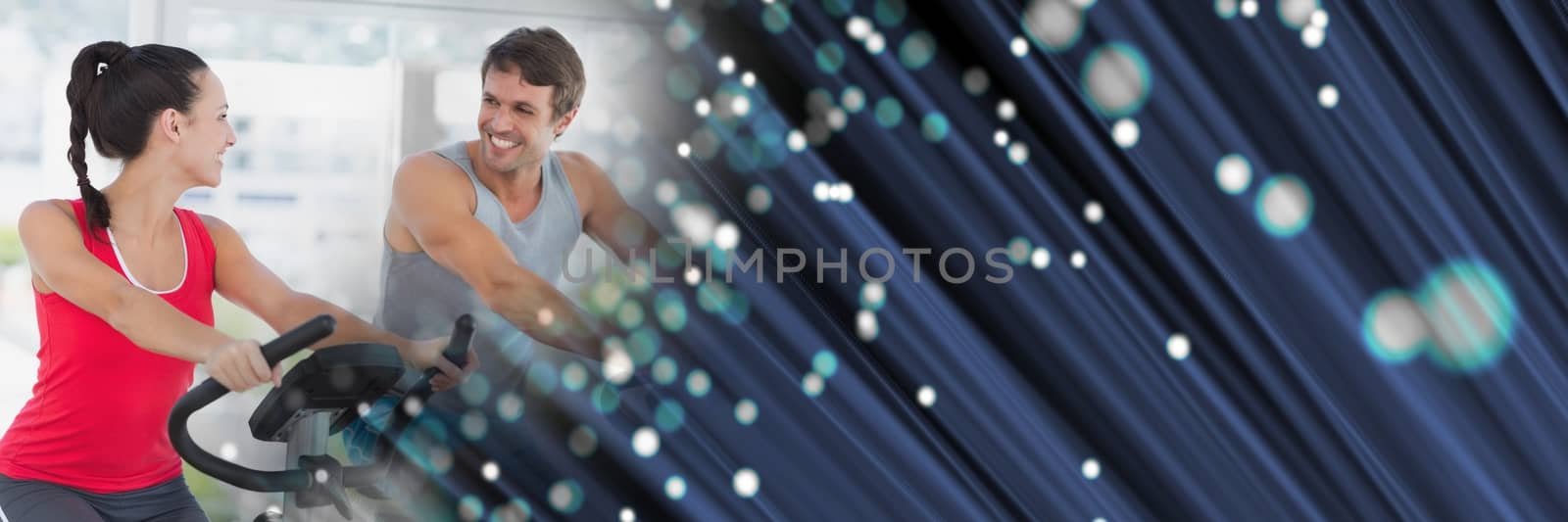 People smiling on gym bikes with blue fibre optics transition by Wavebreakmedia