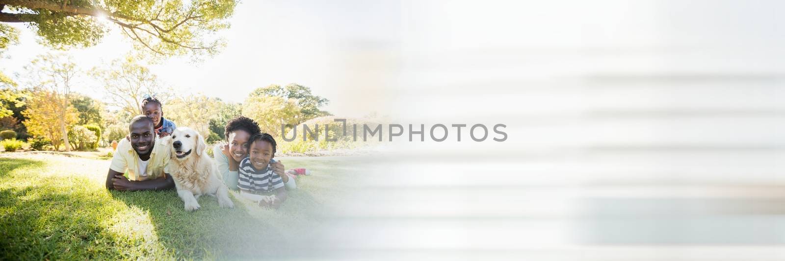 Digital composite of Family lying on grass and blurry white transition
