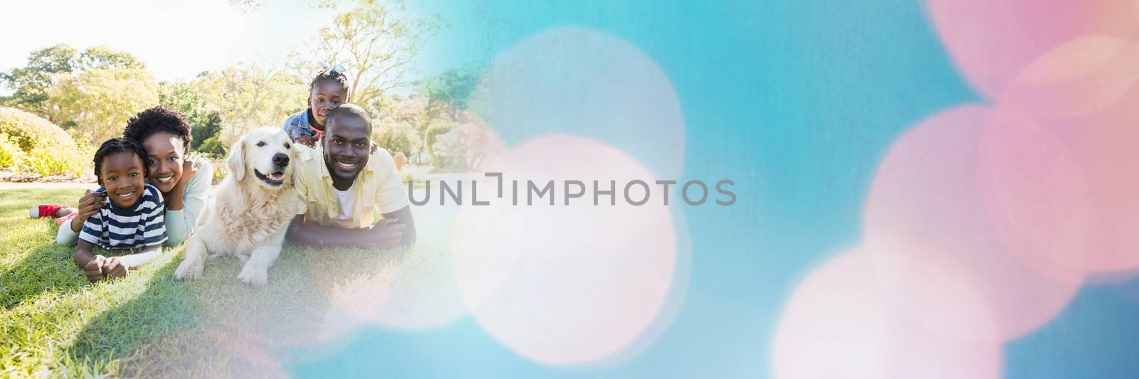 Digital composite of Family lying on grass with blue and pink bokeh transition